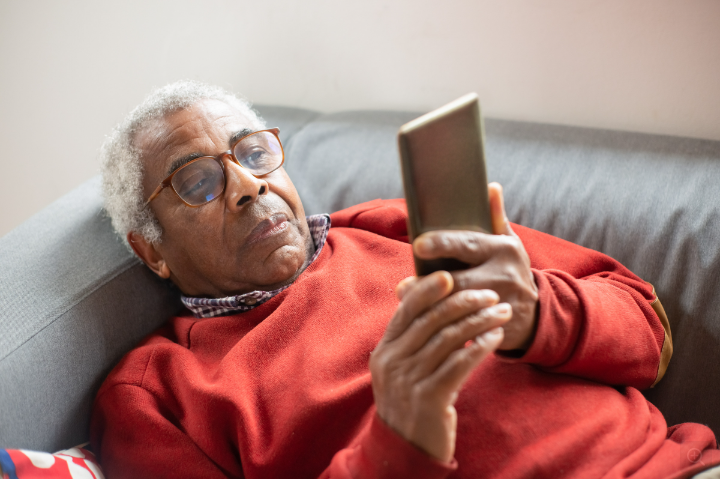 An elderly user with his iPhone.