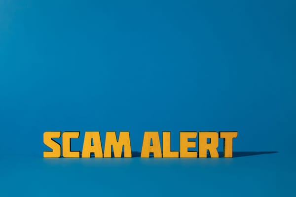 The words SCAM ALERT on a blue background